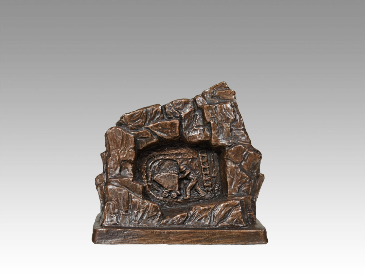 Gallery, Rock Scene with Pushing Ore Sculptural Relief, $175 CAD, Metal Infused, 6” L x 6" H, Pushing Ore Relief Ed.80, Mining Sculpture of a rock with a sculptural relief of a Miner pushing an ore cart inside, Sculptor Tyler Fauvelle